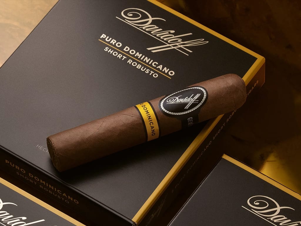 Cigar resting on a Davidoff Puro Dominicano box, rich brown with black and yellow bands, creating a luxurious and sophisticated atmosphere.