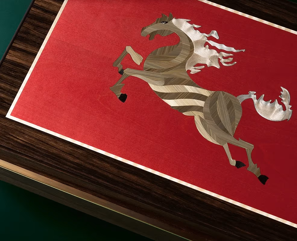 Wooden art piece of a galloping horse on a red background, highlighting detailed craftsmanship.